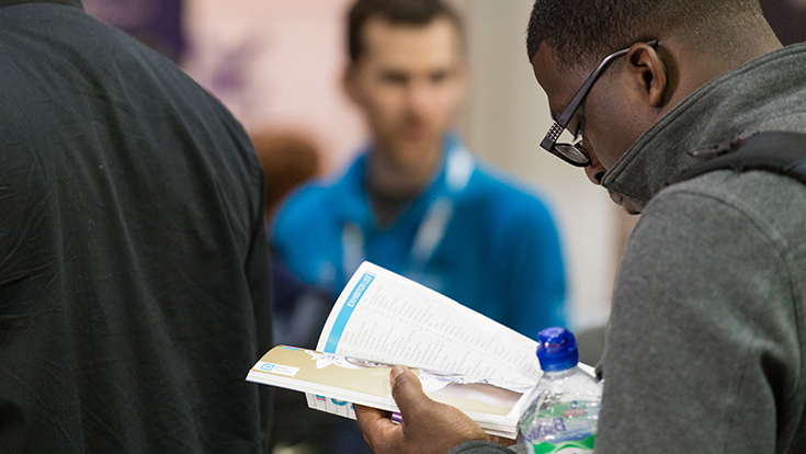 Photo of a visitor reading the show guide at CRE