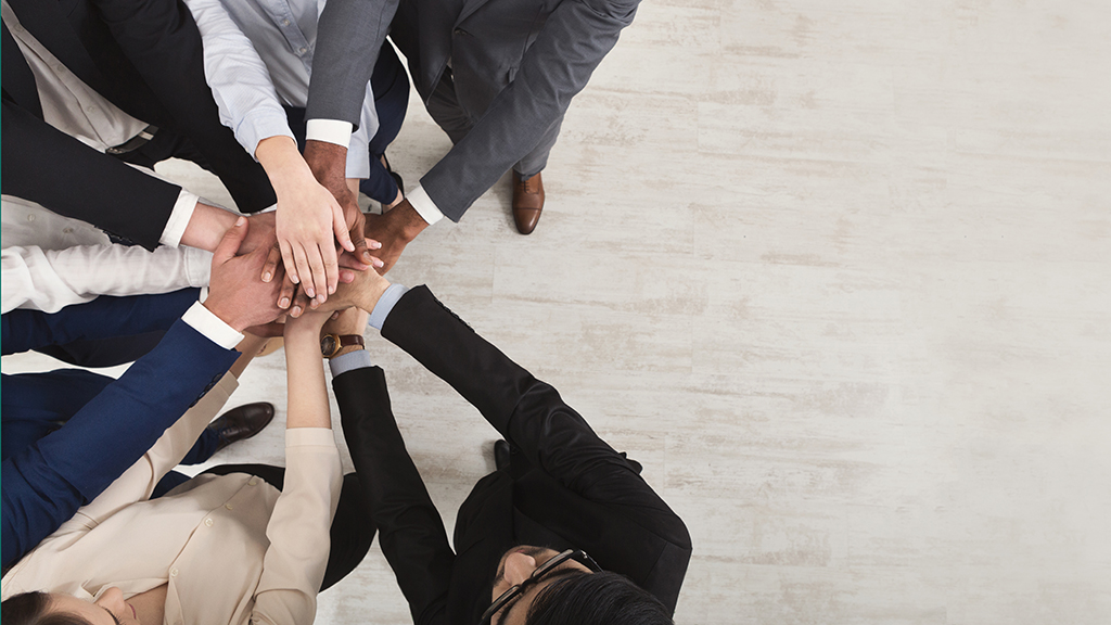 Photo of a group of people holding hands