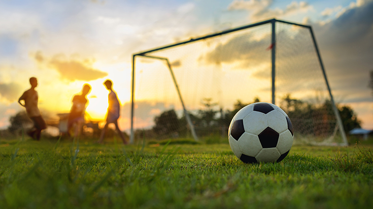 Photo of football pitch at sunset